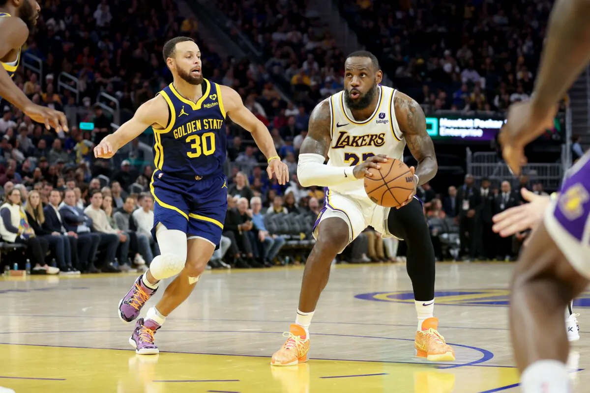 LeBron James (23) of the Los Angeles Lakers is guarded by Stephen Curry (30) of the Golden State Warriors in the first half at Chase Center in San Francisco on Jan. 27, 2024.(Ezra Shaw/Getty Images)
