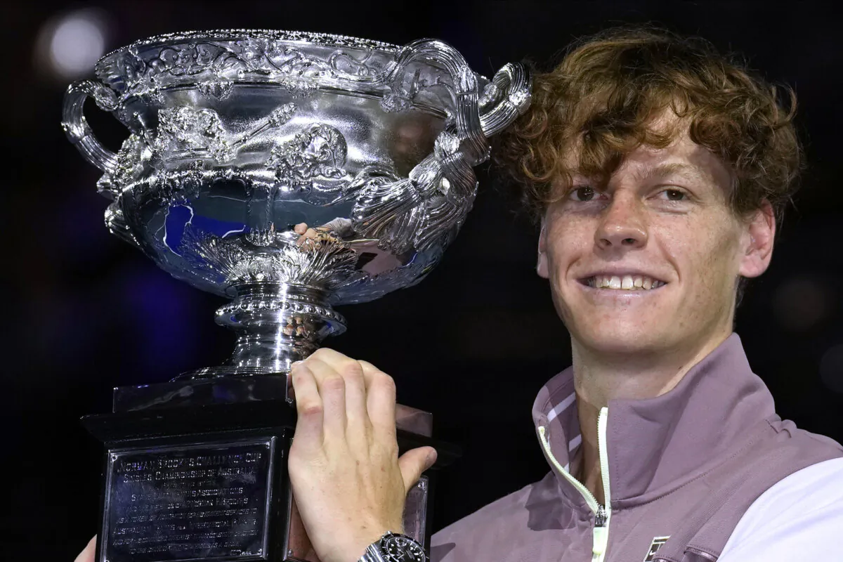 Jannik Sinner of Italy holds the Norman Brookes Challenge Cup aloft after defeating Daniil Medvedev of Russia in the men's singles final at the Australian Open tennis championships at Melbourne Park, in Melbourne, Australia, on Jan. 28, 2024. (Andy Wong/AP Photo)