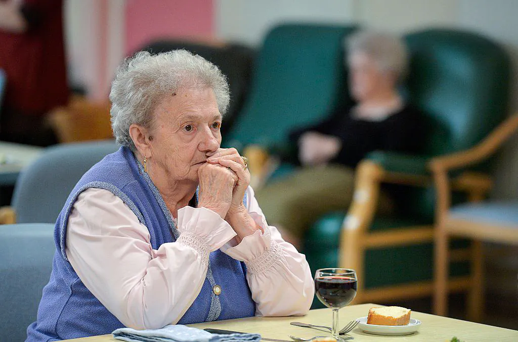 A woman with Alzheimer's disease looks on during lunch in the refectory of a retirement home  in Saint Quirin, eastern France on Oct. 18, 2016. (Patrick Hertzog/AFP via Getty Images)