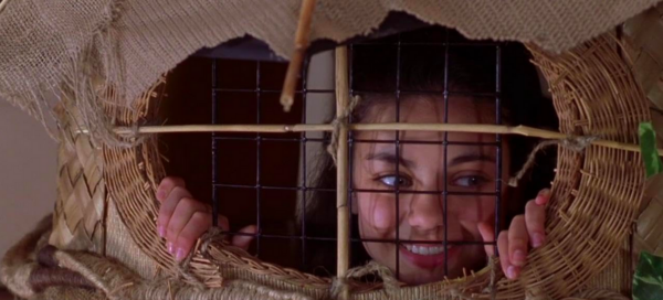 girl in a cage in "Krippendorf's Tribe"