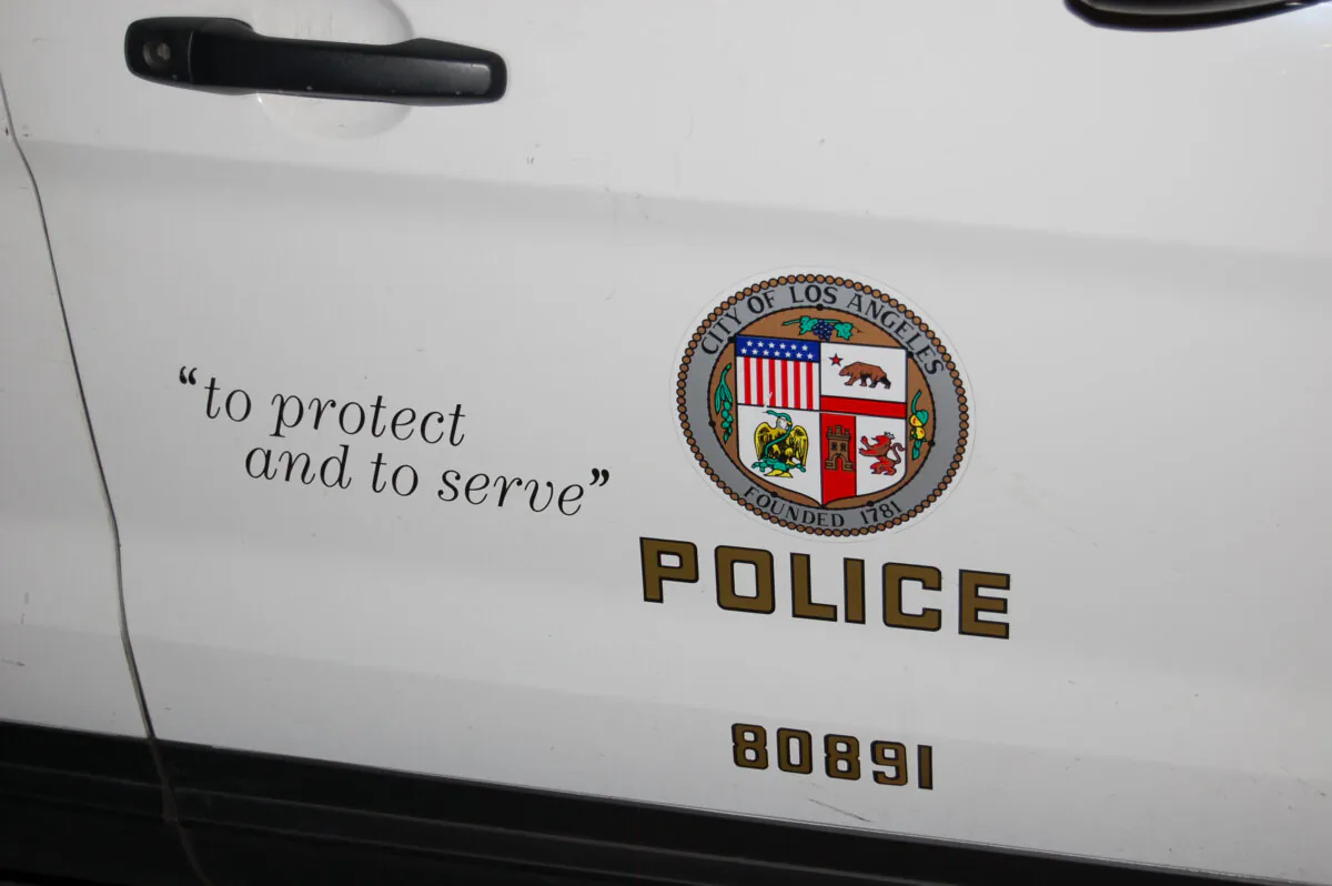 The passenger door of a Los Angeles Police Department squad car with the police seal and the words "To Protect and to Serve" in Los Angeles on March 4, 2020. (Mary at T-Comms/Shutterstock)