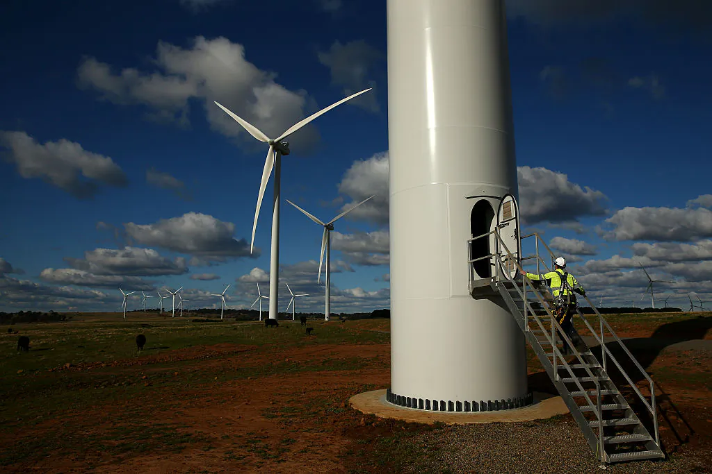 Rory House a Vestas service technician walks up the stairs to the door at the base of a wind turbine at the Taralga Wind Farm in Taralga, Australia, on Aug. 31, 2015. (Mark Kolbe/Getty Images)