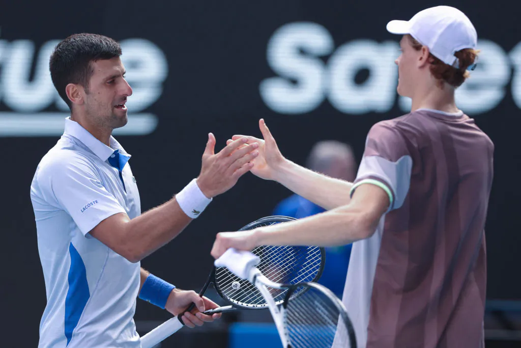 Italy's Jannik Sinner greets Serbia's Novak Djokovic (L) after victory in their men's singles semi-final match on day 13 of the Australian Open tennis tournament in Melbourne, Australia, on Jan. 26, 2024. (Martin Keep/AFP via Getty Images)