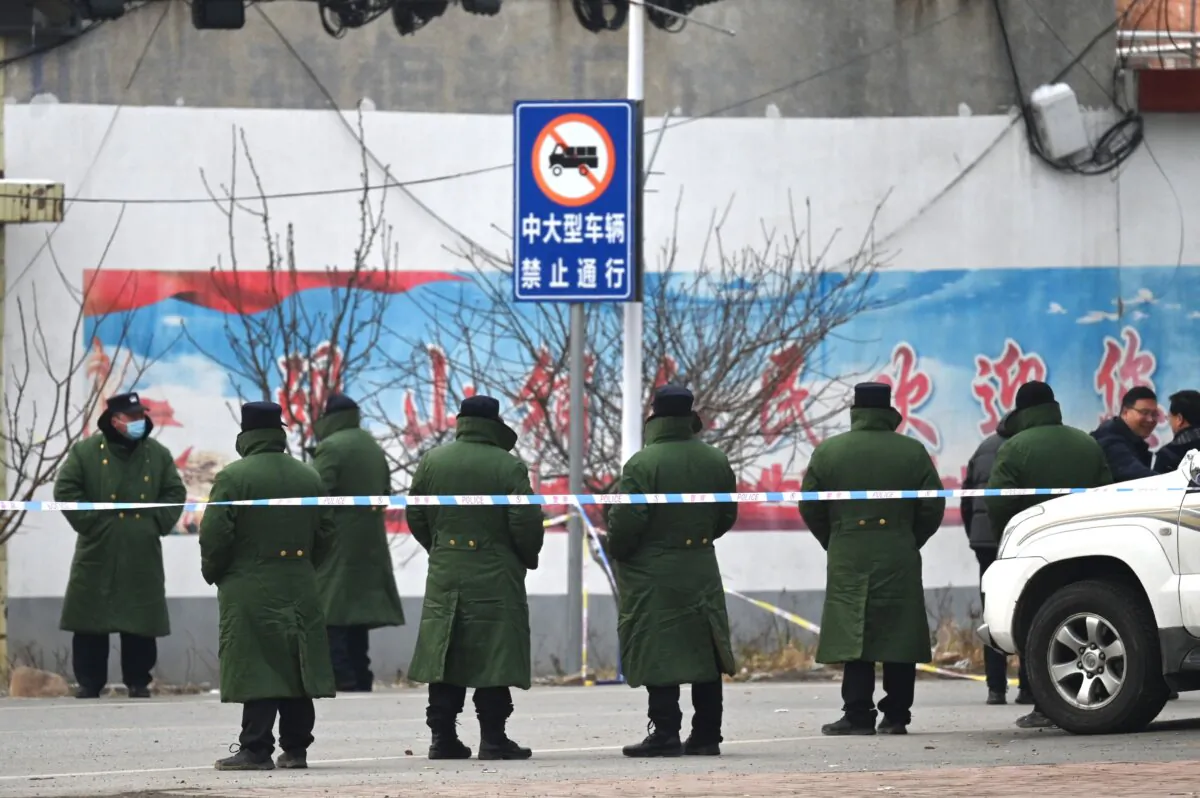 Police stand outside a school where 13 people died in a fire in China's central Henan Province, on Jan. 21, 2024. (Greg Baker/AFP/Getty Images)