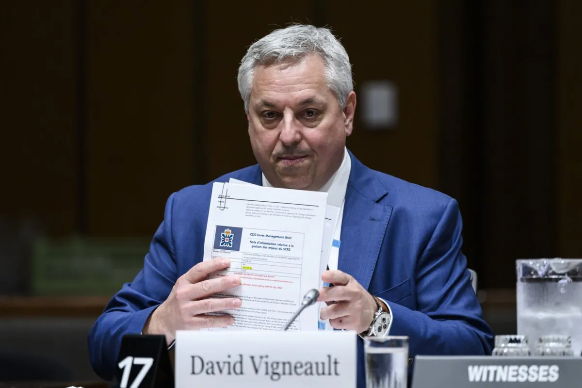 David Vigneault, Director of the Canadian Security Intelligence Service (CSIS), organizes his notes as he prepares to appear before the Standing Committee on Procedure and House Affairs (PROC), studying the intimidation campaign against Members of Parliament, on Parliament Hill in Ottawa, on June 13, 2023. (The Canadian Press/Justin Tang)