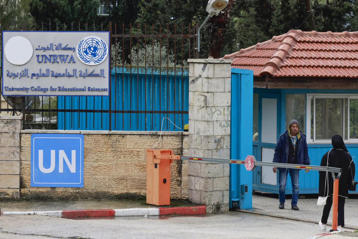 Palestinians stand at the entrance of the UNRWA-run University College for Educational Science Ramallah city in the West Bank on Jan. 29, 2024. (Jaafar Ashtiyeh/AFP via Getty Images)