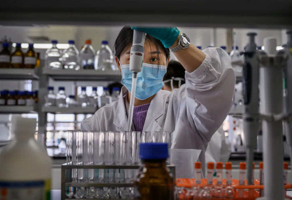 A technician works in a lab at Sinovac Biotech in Beijing on Sept. 24, 2020. Sinovac recently halted production of its COVID-19 vaccine. (Kevin Frayer/Getty Images)