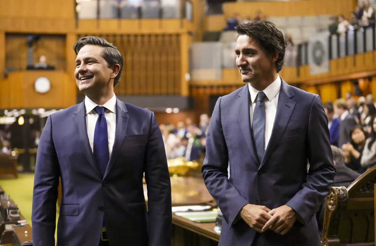 Prime Minister Justin Trudeau (R) and Conservative Leader Pierre Poilievre wait to continue escorting newly elected Speaker of the House of Commons Greg Fergus to his seat, on Parliament Hill in Ottawa, on Oct. 3, 2023. (The Canadian Press/Sean Kilpatrick)