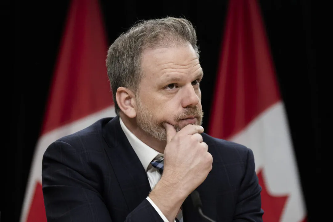 Federal Health Minister Mark Holland listens to a question from a reporter during a news conference, in Ottawa on Dec. 12, 2023. (The Canadian Press/Adrian Wyld)