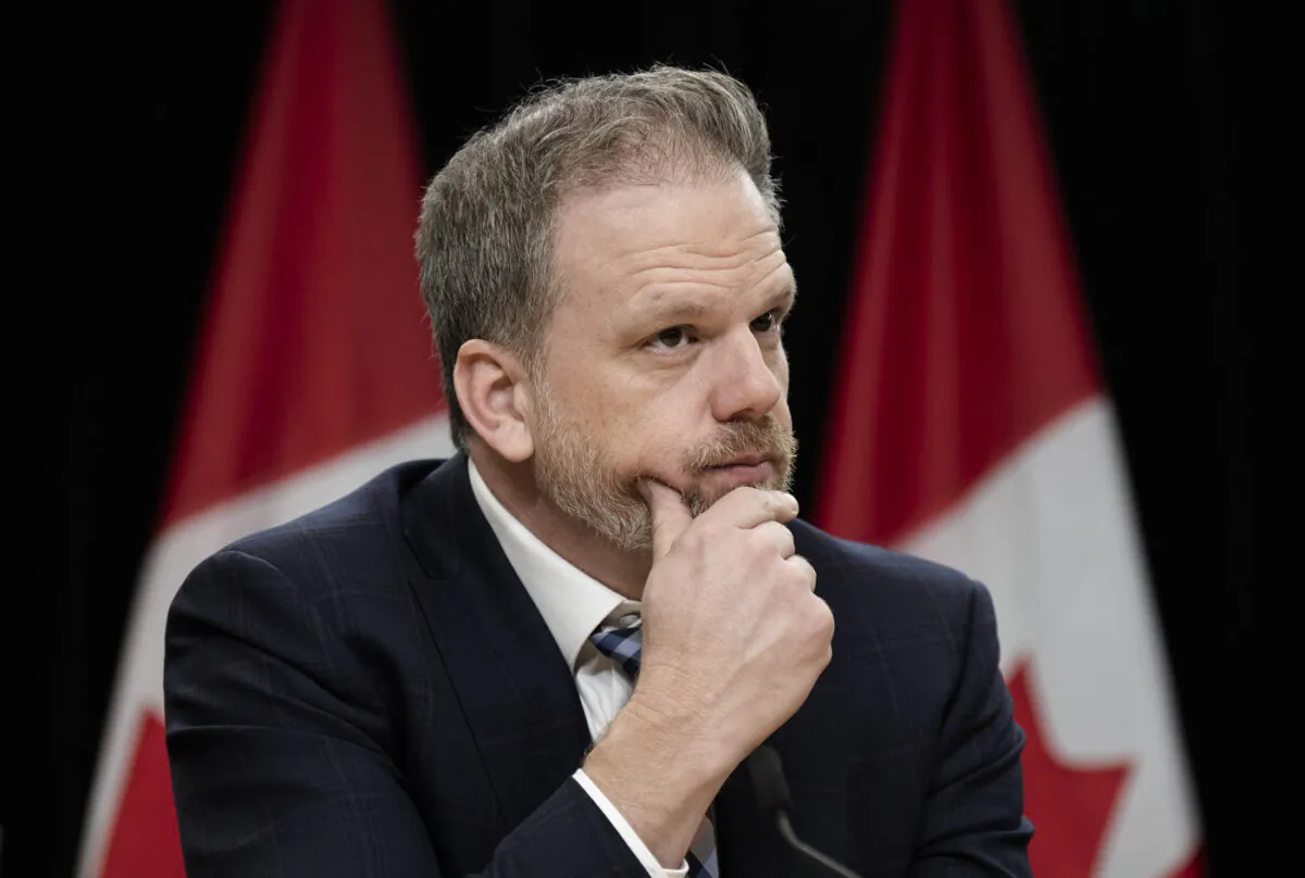 Federal Health Minister Mark Holland listens to a question from a reporter during a news conference, in Ottawa on Dec. 12, 2023. (The Canadian Press/Adrian Wyld)