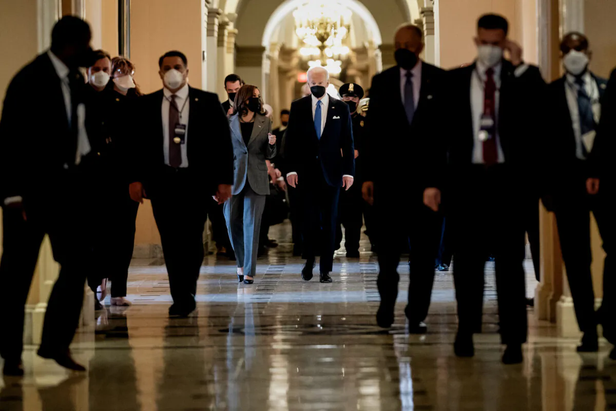 Vice President Kamala Harris (L) and President Joe Biden (R) walk through the Hall of Columns at the U.S. Capitol, on Jan. 6, 2022. (Stefani Reynolds-Pool/Getty Images)