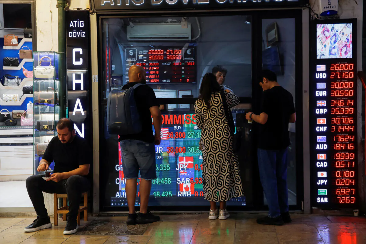 People visit a currency exchange office in Istanbul, Turkey, on July 18, 2023. (Dilara Senkaya/Reuters)