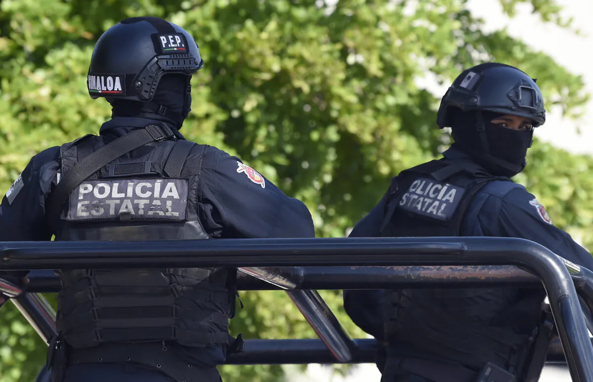 Policemen stand guard in the area where heavily armed gunmen waged an all-out battle against Mexican security forces in Culiacan, Sinaloa state, Mexico, on Oct. 18, 2019. (Alfredo Estrella/AFP via Getty Images)