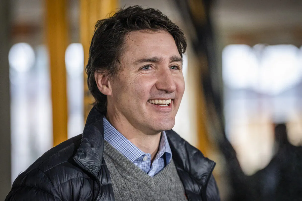 Trudeau smiles at the media before a news conference for a housing announcement in Vancouver, B.C., Dec. 15, 2023. (The Canadian Press/Ethan Cairns)
