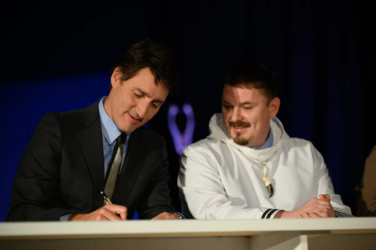 Prime Minister Justin Trudeau and Nunavut Premier P.J. Akeeagok sign the Nunavut devolution agreement in Iqaluit on Jan. 18, 2024. (The Canadian Press/Dustin Patar)