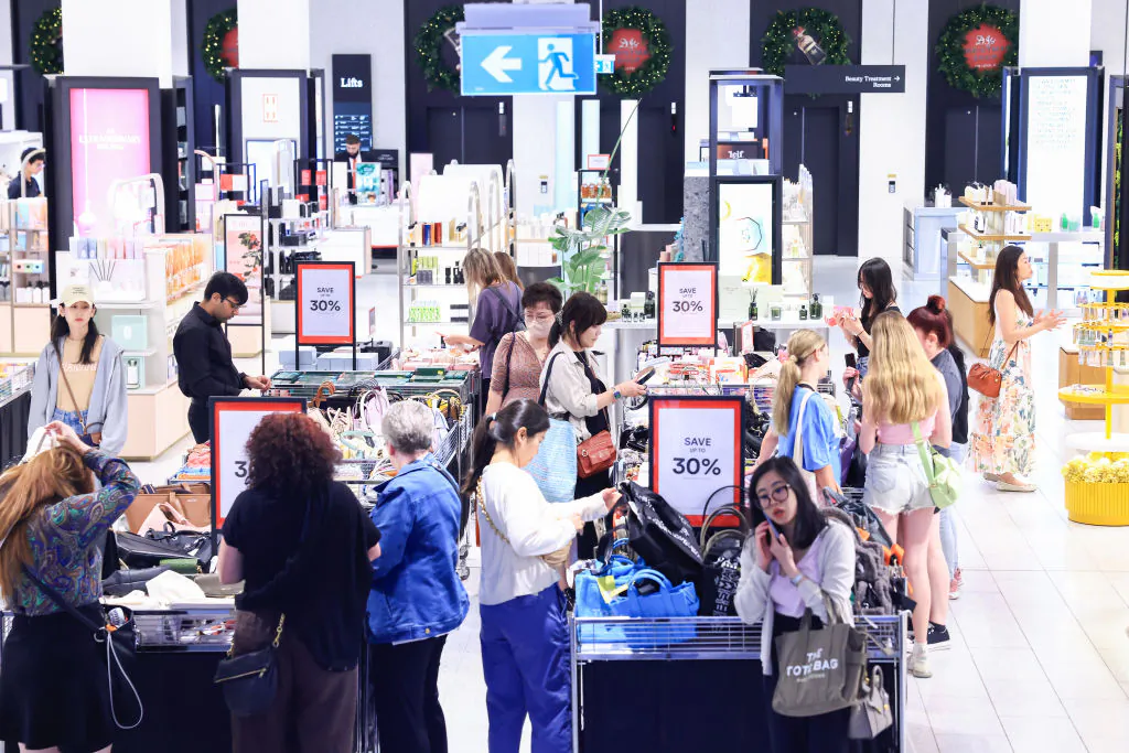 Shoppers looks through the bargain bins at the David Jones flagship store in Sydney, Australia, on Dec. 26, 2023. (Jenny Evans/Getty Images)