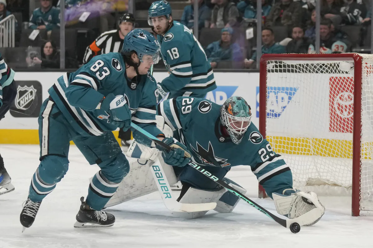 San Jose Sharks goaltender Mackenzie Blackwood (29) reaches for the puck next to defenseman Nikita Okhotiuk (83) during the second period of an NHL hockey game against the Seattle Kraken in San Jose, Calif., on Jan. 30, 2024. (Jeff Chiu/ AP Photo)