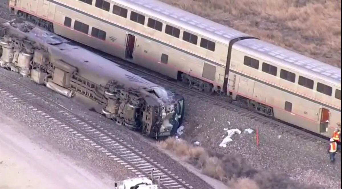 Emergency responders look over an Amtrak train derailment near Keenesburg, Colo., on Jan. 30, 2024. (KMGH via AP)