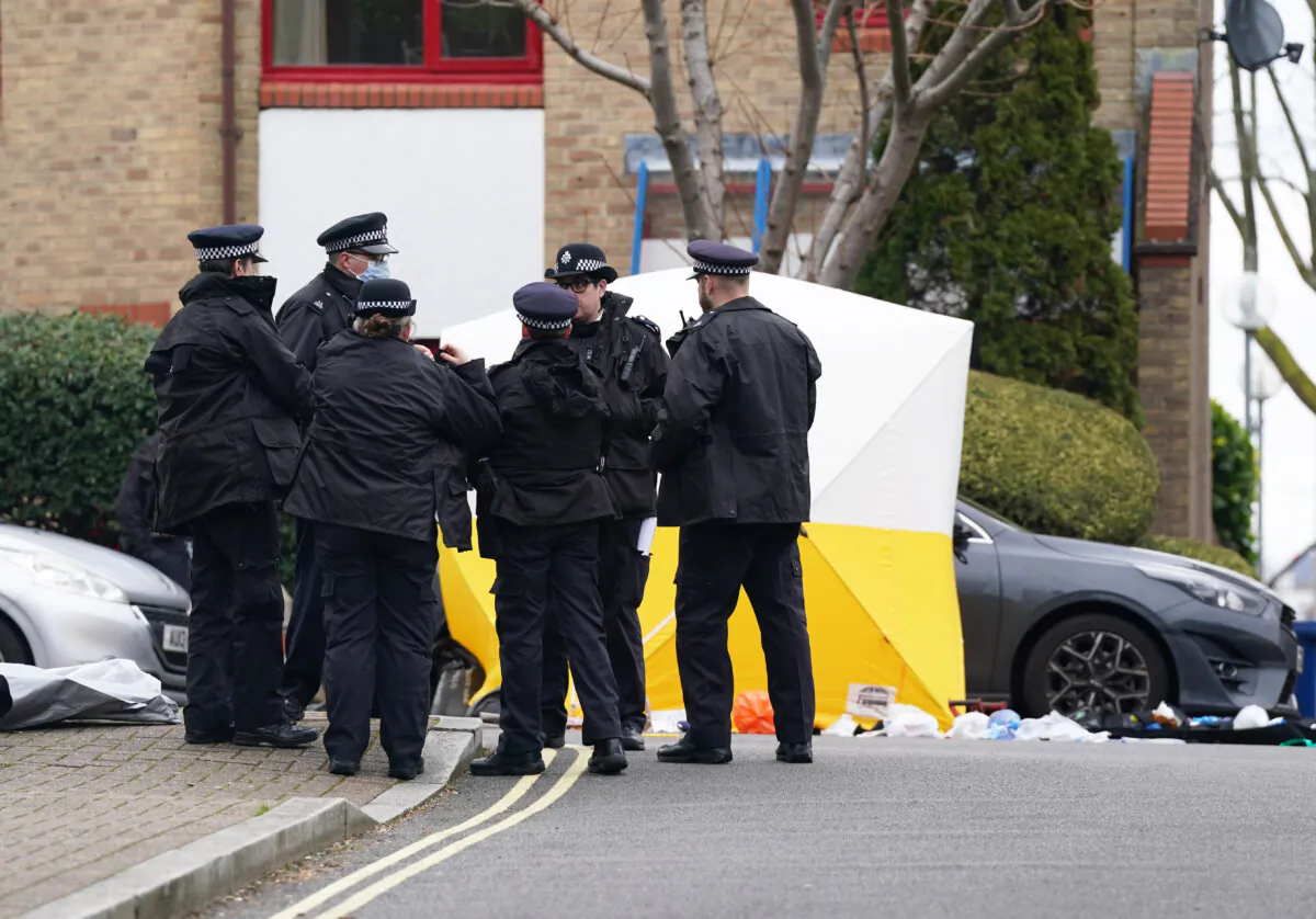 Police officers at the scene where a man armed with a crossbow was shot dead by police in Surrey Quays, south east London on Jan. 30, 2024. (Lucy North/PA Wire)
