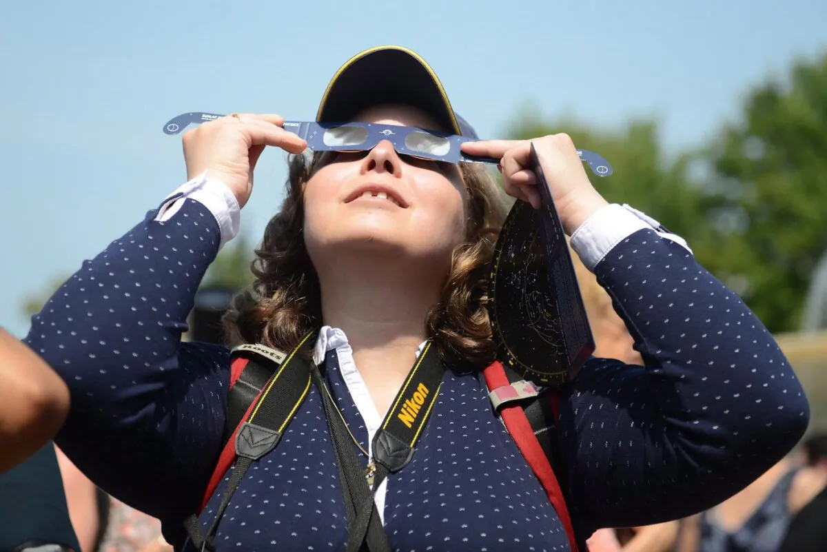 Observers watch a solar eclipse at the Canadian National Exhibition in Toronto on August 21, 2017. (The Canadian Press/Jon Blacker)