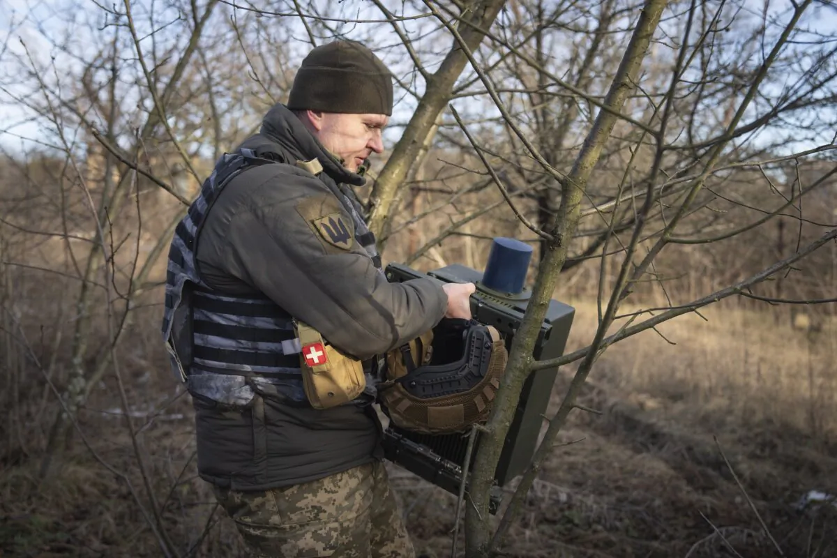 A Ukrainian serviceman installs an electronic warfare system to quell Russian drones at the front line near Bakhmut, Donetsk region, Ukraine, on Jan. 29, 2024. (Efrem Lukatsky/AP Photo)