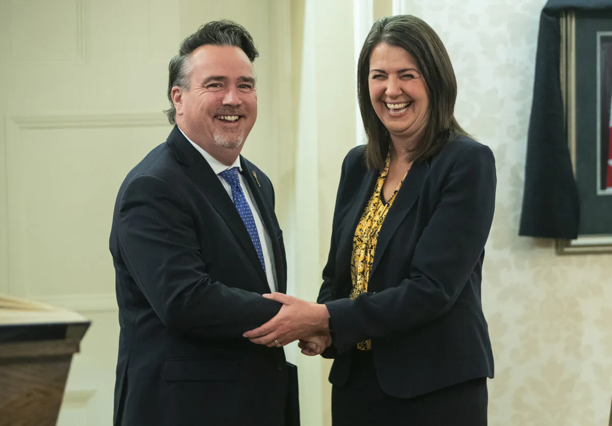 Dale Nally shakes hands with Alberta Premier Danielle Smith after Nally was sworn into cabinet as Minister of Service Alberta and Red Tape Reduction in Edmonton on Oct. 24, 2022. (The Canadian Press/Jason Franson)