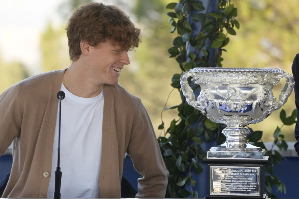 Italian tennis player Jannik Sinner looks at the Australian Open trophy he won on Sunday during a press conference in Rome on Jan. 31, 2024. (Gregorio Borgia/AP Photo)