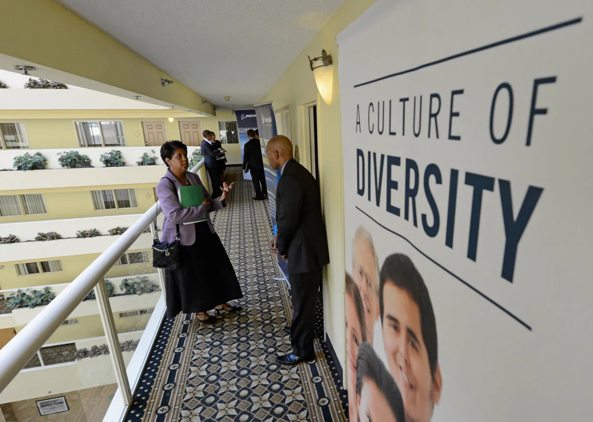 A job seeker speaks with job recruiters during the Professional and Executive Diversity Job Fair at an Embassy Suites hotel in Los Angeles on Nov. 13, 2012. (Kevork Djansezian/Getty Images)