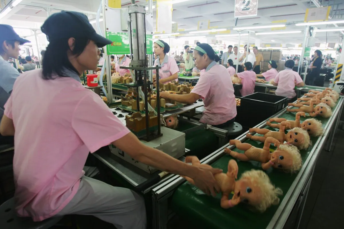 File photo shows workers assembling dolls at a production line in Guangdong, China, on Sept. 4, 2007 (Feng Li/Getty Images)