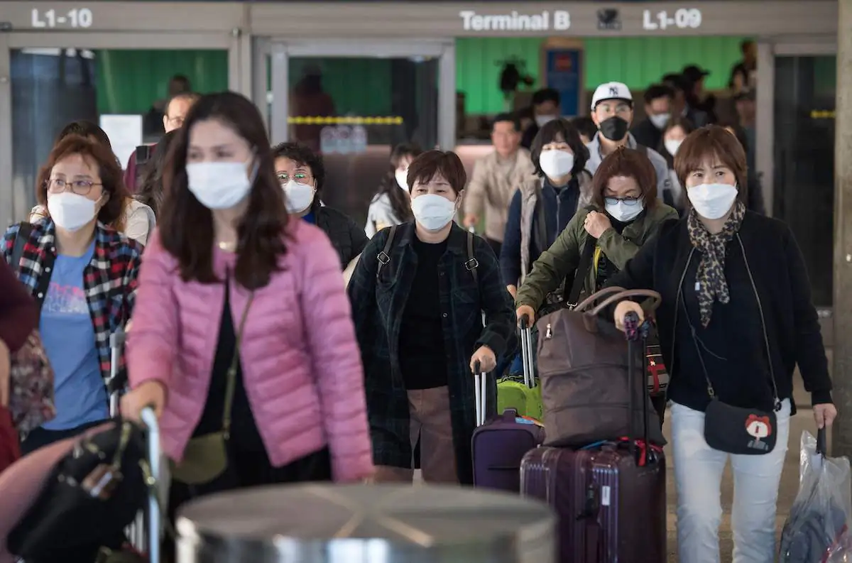 Passengers arrive on a flight from Asia at the Los Angeles International Airport, Calif., on Jan. 29, 2020. (Mark Ralston/AFP via Getty Images)
