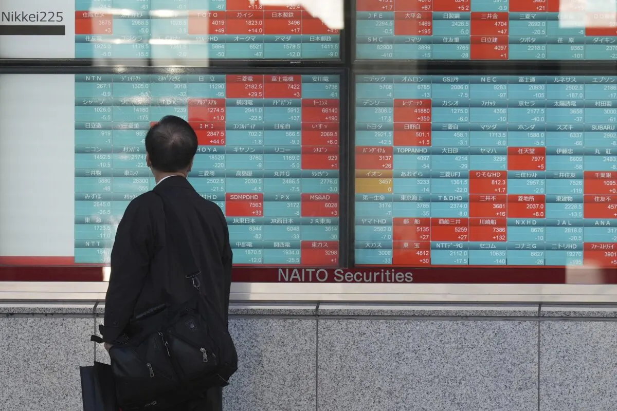 A person looks at an electronic stock board showing Japan's Nikkei 225 index at a securities firm in Tokyo on Jan. 26, 2024. (Eugene Hoshiko/AP Photo)