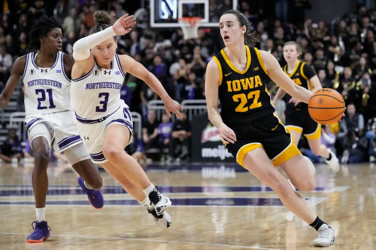 Iowa guard Caitlin Clark (22) drives as Northwestern guard Maggie Pina guards during the first half of an NCAA college basketball game in Evanston, Ill., on Jan. 31, 2024. (Nam Y. Huh/AP Photo)