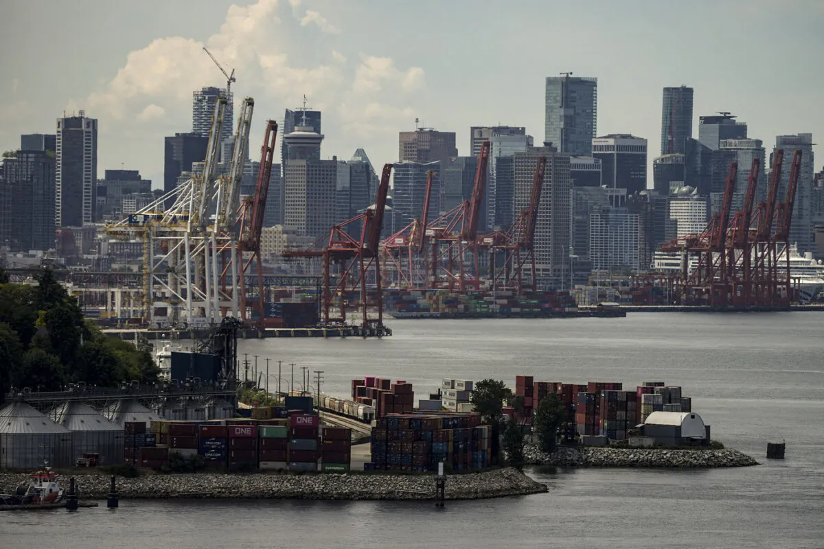 Gantry cranes sit idle above stacks of cargo containers at port during a strike by International Longshore and Warehouse Union Canada workers in the province in Vancouver on July 12, 2023. (The Canadian Press/Darryl Dyck)