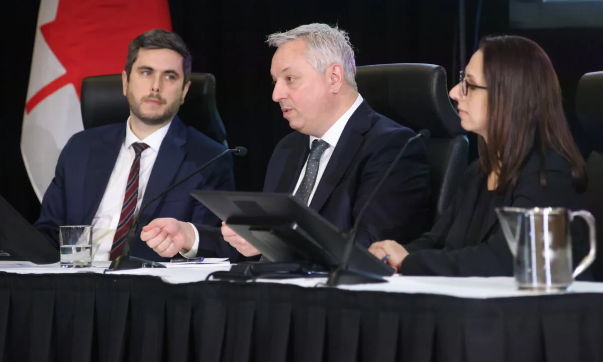 Dan Rogers (L), deputy national security and intelligence advisor, Privy Council Office; David Vigneault, director of the Canadian Security Intelligence Agency, and Alia Tayyeb, deputy chief of signals intelligence, Communications Security Establishment Canada, appear at the Public Inquiry into Foreign Interference in Federal Electoral Processes and Democratic Institutions hearings, in Ottawa on Feb. 1, 2024. (Patrick Doyle/The Canadian Press)