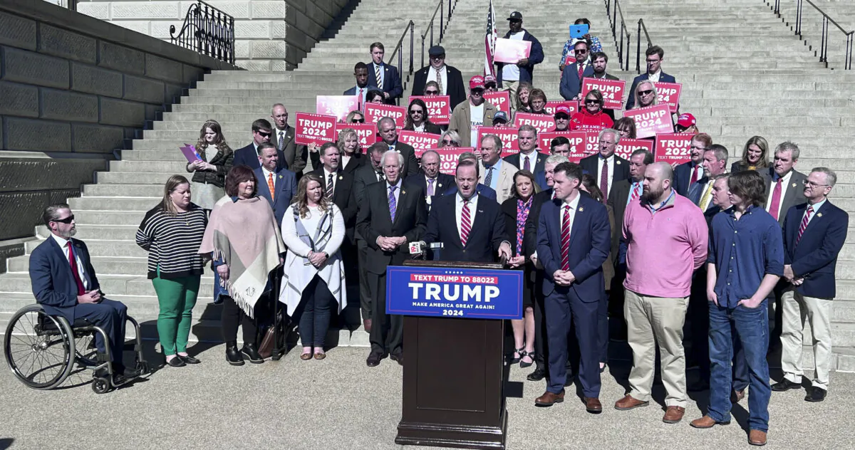 People supporting former President Donald Trump's reelection bid, including South Carolina Attorney General Alan Wilson (C), gather on the steps of the Statehouse in Columbia, S.C., on Feb. 1, 2024. (Lawrence Wilson/The Epoch Times)