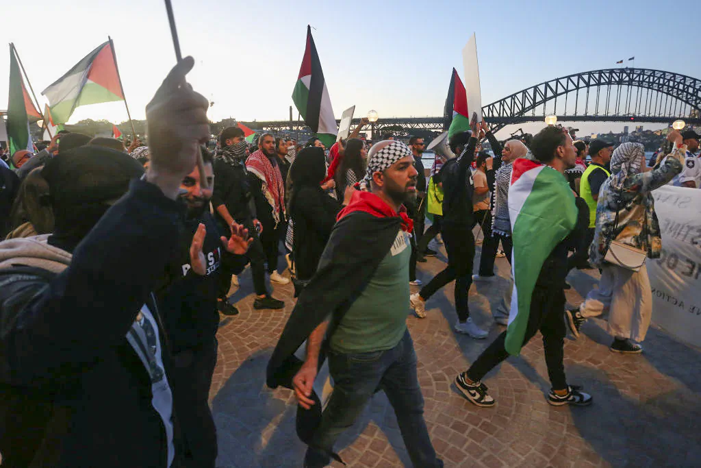 Palestine supporters rally outside the Sydney Opera House on Oct. 9, 2023 in Sydney, Australia. The Palestinian militant group Hamas launched a surprise attack on Israel from Gaza by land, sea, and air, over the weekend, killing over 600 people and wounding more than 2000, agency reports said. Reports also said Israeli soldiers and civilians have been kidnapped by Hamas and taken into Gaza. The attack prompted a declaration of war by Israeli Prime Minister Benjamin Netanyahu, and ongoing retaliatory strikes by Israel on Gaza killing hundreds in the aftermath. (Photo by Lisa Maree Williams/Getty Images)