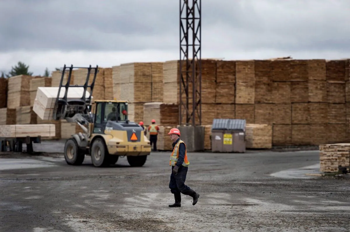 An employee walks across the lumber yard at Ledwidge Lumber Co. in Halifax on May 10, 2017. (The Canadian Press/Darren Calabrese)
