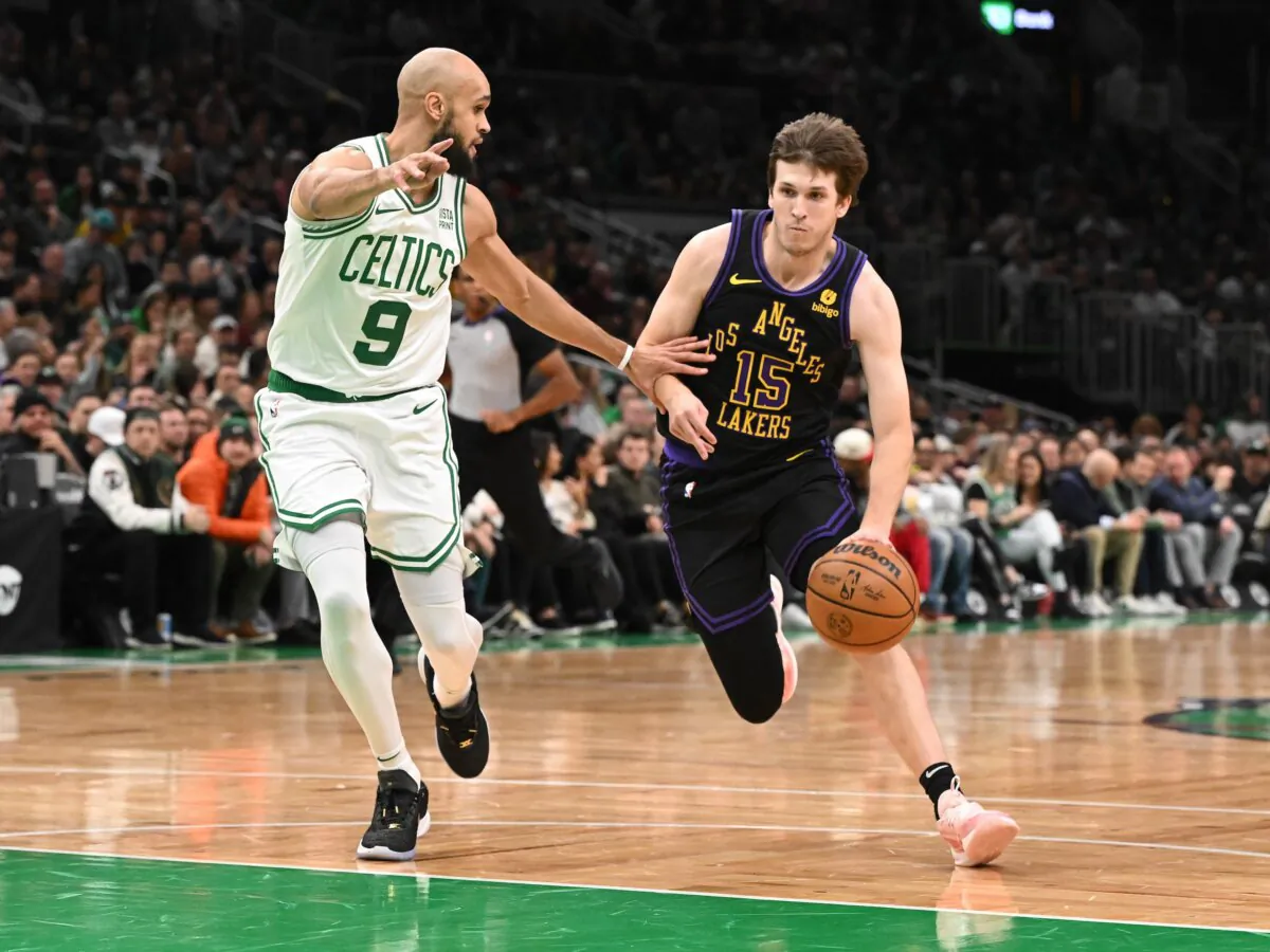 Austin Reaves (15) of the Los Angeles Lakers dribbles the ball against Derrick White (9) of the Boston Celtics during the first quarter in Boston on Feb. 1, 2024. (Brian Fluharty/Getty Images)
