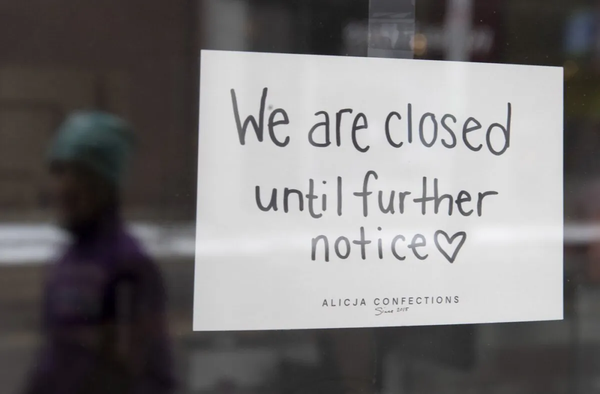 A sign on a shop window indicates the store is closed in Ottawa, on March 23, 2020. (The Canadian Press/Adrian Wyld)
