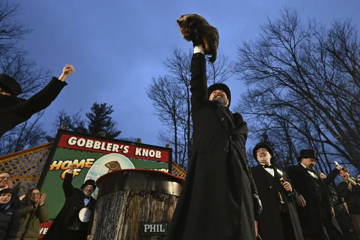 Groundhog Club handler A.J. Dereume holds Punxsutawney Phil, the weather prognosticating groundhog, during the 138th celebration of Groundhog Day on Gobbler's Knob in Punxsutawney, Pa., on Feb. 2, 2024. (Barry Reeger/AP Photo)