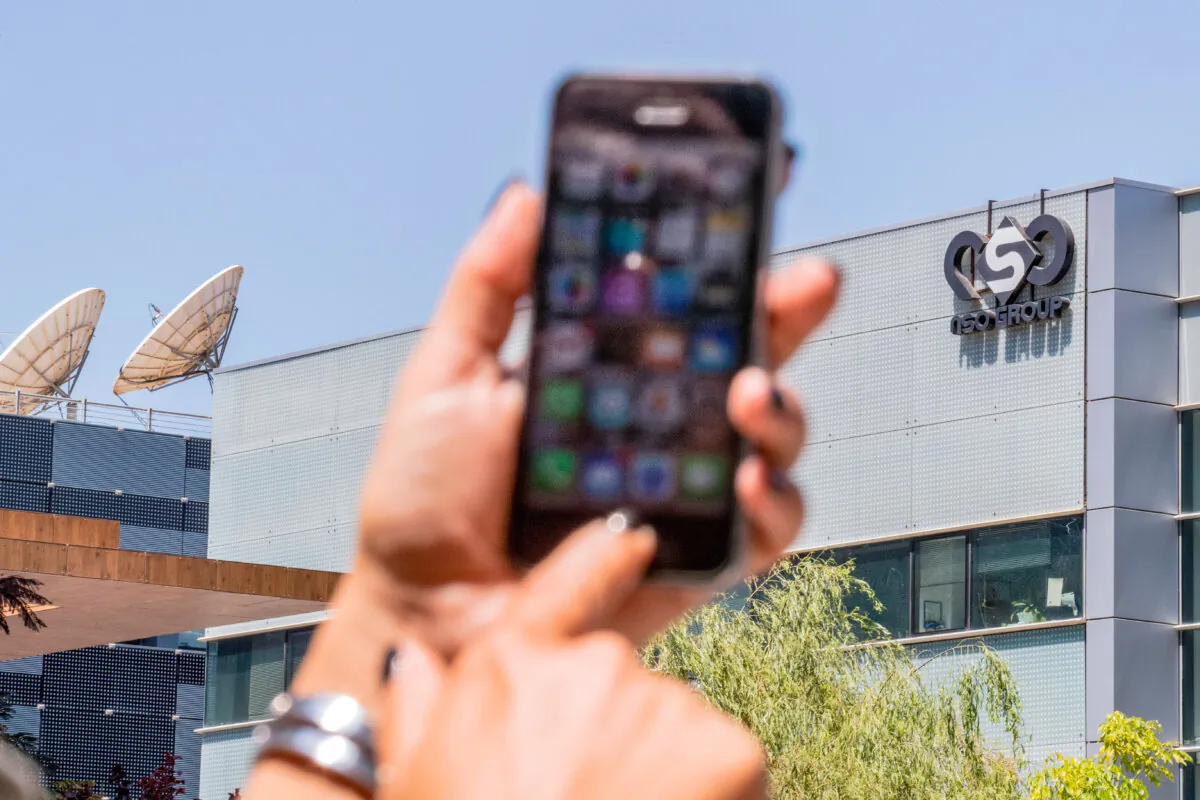 An Israeli woman uses her iPhone in front of the building housing the Israeli NSO group in Herzliya, near Tel Aviv, on Aug. 28, 2016. (Jack Guez/AFP via Getty Images)