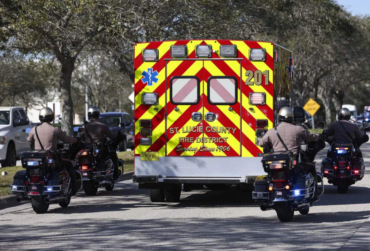 Law enforcement escorts an ambulance carrying Florida Highway Patrol Trooper Zachary Fink's body from Lawnwood Hospital in Fort Pierce, Fla., on Feb. 2, 2024. (Crystal Vander Weit/TCPalm.com via AP)