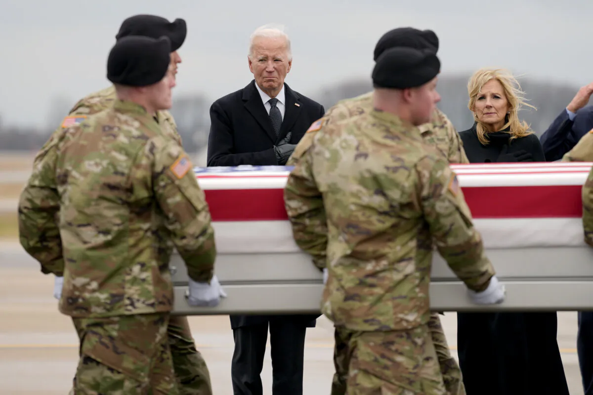 President Joe Biden (3rd L) and First Lady Jill Biden (R) stand as an Army carry team moves the transfer case containing the remains of U.S. Army Sgt. Kennedy Ladon Sanders, 24, of Waycross, Ga., at Dover Air Force Base, Del., on Feb. 2, 2024. (Matt Rourke/AP Photo)