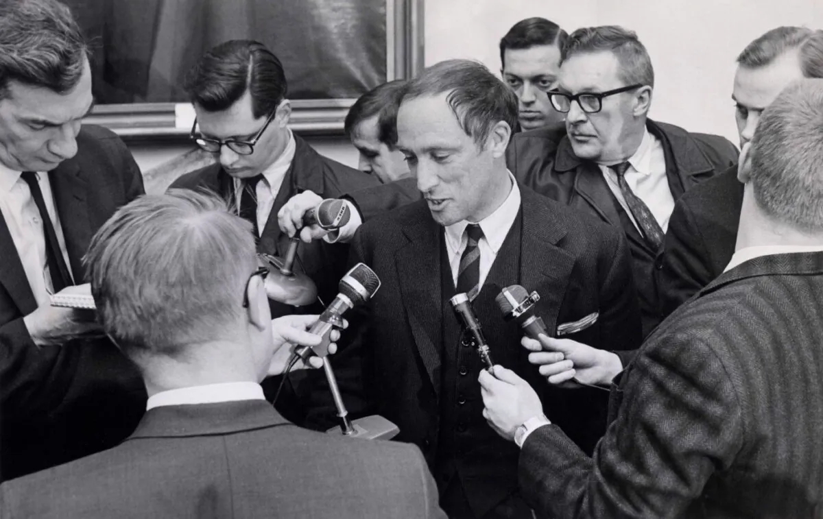 Reporters swarm around Pierre Trudeau after he was sworn-in as justice minister in Ottawa on April 4, 1967. (The Canadian Press/Chuck Mitchell)
