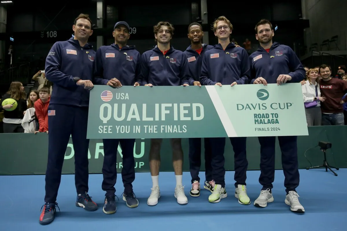 USA Davis Cup Team, captain Bob Bryan (L–R), Rajeev Ram, Taylor Fritz, Christopher Eubanks, Sebastian Korda and Austin Krajicek hold the "Qualified" banner after winning the Davis Cup Qualifier match between Ukraine and USA in Vilnius, Lithuania, on Feb. 2, 2024. (Tim Ireland/Getty Images for ITF)