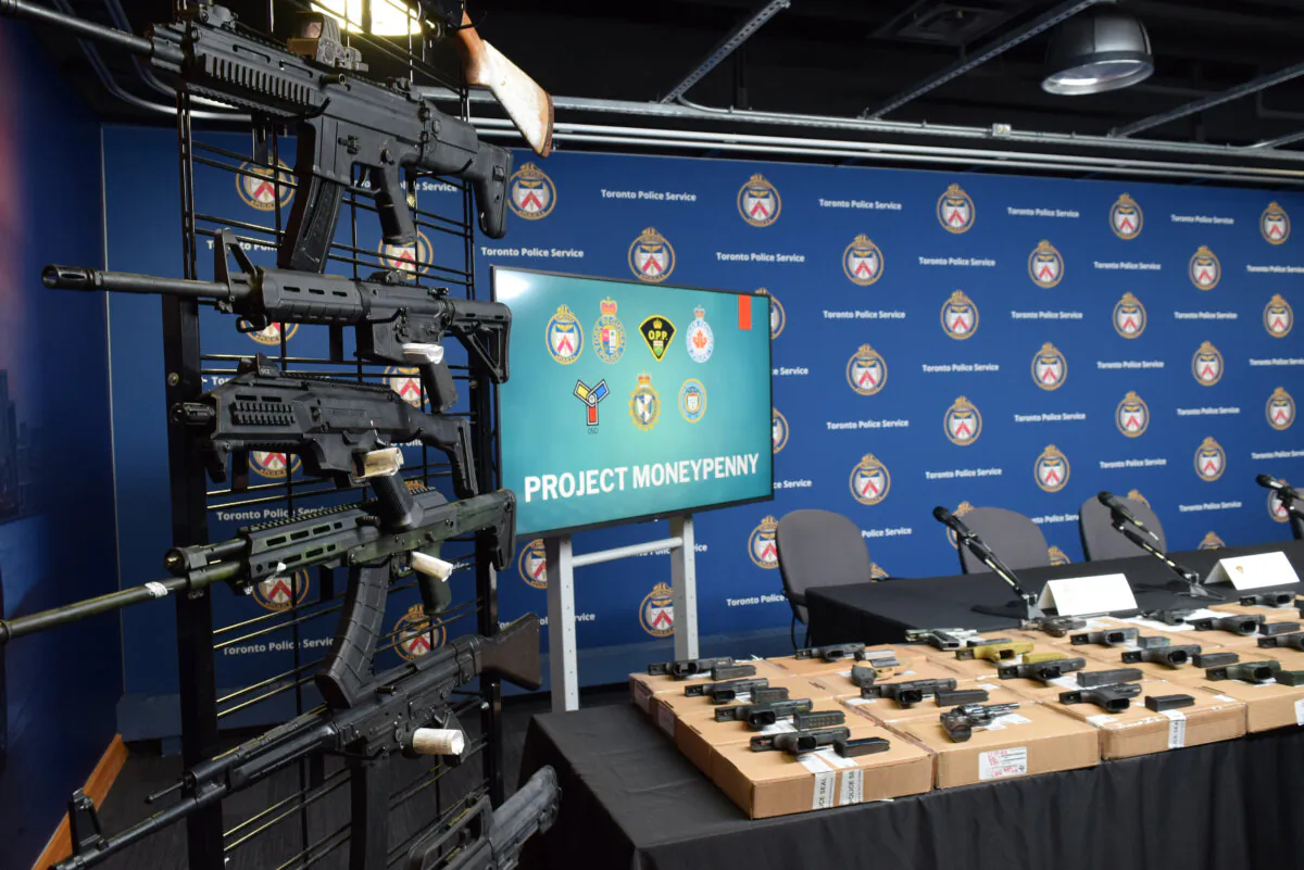 Police display seized firearms taken as part of an investigation called Operation Moneypenny in Toronto on April 11, 2023. A cross-border firearms trafficking investigation led to the arrests of 42 people and the seizure of 173 guns, police said. (The Canadian Press/Kiernan Green)