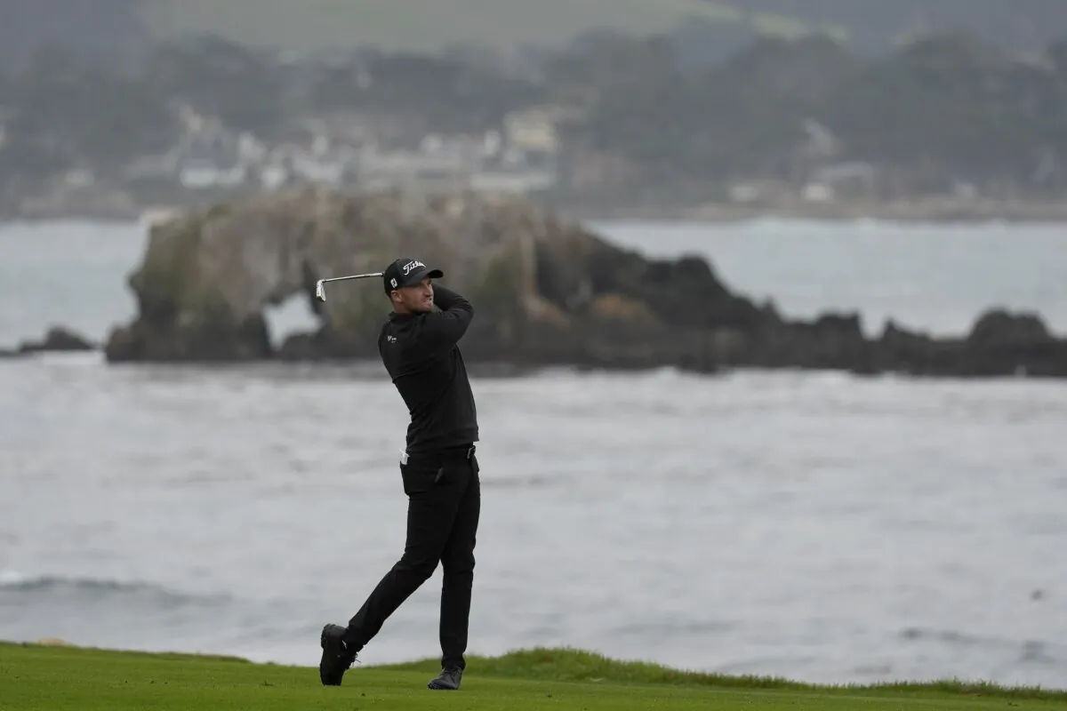 Wyndham Clark hits from the 18th fairway at Pebble Beach Golf Links during the third round of the Pebble Beach National Pro-Am golf tournament in Pebble Beach, Calif., on Feb. 3, 2024. (Ryan Sun/AP Photo)