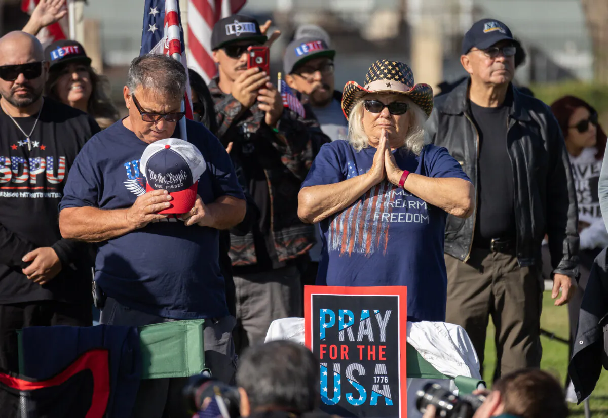 Participants of a convoy protesting U.S. border policies pray together in San Ysidro, Calif., on Feb. 3, 2024. (John Fredricks/The Epoch Times)