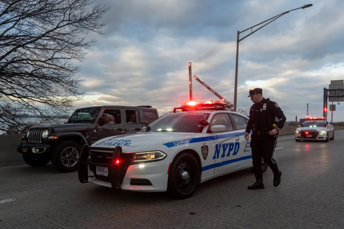 New York Police Department officers stop a vehicle containing supporters of Palestine near LaGuardia Airport as people targeted JFK and LaGuardia airport with protests in New York on Jan. 1, 2024. (Adam Gray/Getty Images)
