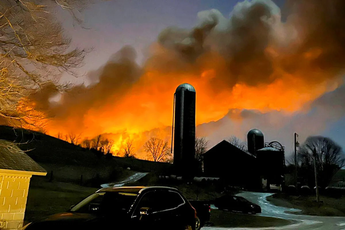 Fire from a burning train is seen from a farm in East Palestine, Ohio, on Feb. 3, 2023. (Melissa Smith via AP)